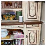 cabinet doors centering three open shelves, the lower section having three drawers over two cabinet 