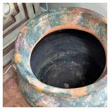 terracotta pot with old paint, having two decorative side handles, the bottom drilled with a hole fo