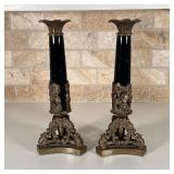 PAIR CANDLESTICK HOLDERS | Black enamel porcelain column on a shaped brass base with floral motif; h