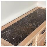 Black marble top side cabinet of light wood, with three drawers over three cabinet doors; h. 36 x w.