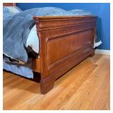 bed frame of nicely figured dark wood, with low footboard, likely by Young America; fits mattress 71