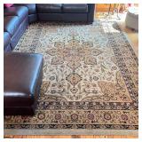 MEDALLION ROOMSIZE CARPET | Having a central medallion on a cream field within brown floral borders 