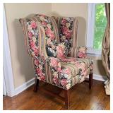 Armchair with overall floral upholstery with matching cushion on carved square legs with back splaye