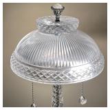 Having a domed shade covering two lights with crystal drop pulls, supported by a crystal column on a