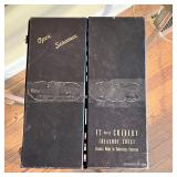 stainless blades with black handles and 24k gold plating, in a carrying case; appearing in overall v