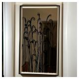 DECORATIVE WALL MIRROR | Mirror with swirling reed overlay decoration within a black painted frame w