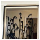Mirror with swirling reed overlay decoration within a black painted frame with a white interior trim