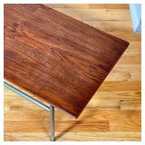 in the manner of Gio ponti, with a single piece wood top "floating" on a tubular metal frame - h. 13