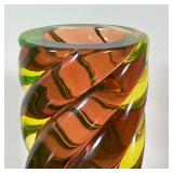 pink, yellow, and green glass in a twisted cylindrical form