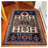 GEOMETRIC AREA RUG | With blue, green, and red geometric devices within concentric geometric borders