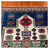 GEOMETRIC AREA RUG | With blue, green, and red geometric devices within concentric geometric borders
