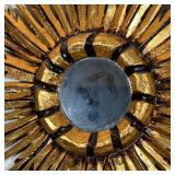 Central round mirror centered by feather form gilt painted carved wood sunburst motif - 16 x 15 in.