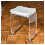 ROLLING LUCITE STOOL | Vintage mid-century lucite bench set on casters, with a white vinyl upholster