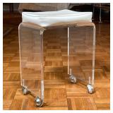 Vintage mid-century lucite bench set on casters, with a white vinyl upholstered cushion - h. 19 in x