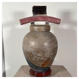 urn with figural handle and gradient striations on the body, apparently unsigned, on a separate wood