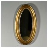 GILT OVAL WALL MIRROR | Gilt frame wall mirror of oblong oval shape - 19-1/4 x 10-1/2 in.
