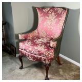 wingback form, the back and armrests with green leather and brass tacking, cushion with needlepoint 