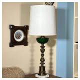 GREEN GLASS FLUID LAMP | A 20th century copy of an antique fluid lamp on a white stone base - h. 36 