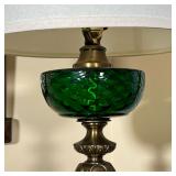 GREEN GLASS FLUID LAMP | A 20th century copy of an antique fluid lamp on a white stone base - h. 36 