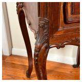 side table with two drawers and shell carvings, cabriole legs terminating in casters, with a conform