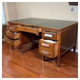kneehole desk with two banks of three drawers centering a middle drawer; interesting drawer mechanis