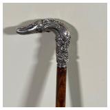 SILVER HANDLED WALKING STICK | Cane with a repousse sterling silver handle - l. 33 in.