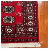 BOKHARA MAT | With five central medallions within a flower border, on a red ground - 3 ft. 2 in. x 2