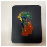 ENAMELED MAYAN HEAD | Colorful enameled Mayan figure mounted on a black painted board, with label on