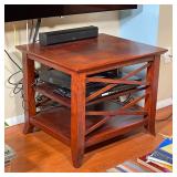 WOODEN SIDE TABLE WITH OPEN SHELVES | Dark wooden side table with cross pattern side frame and contr