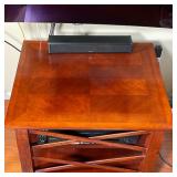 Dark wooden side table with cross pattern side frame and contrasting wood top - h. 23 x w. 28 x d. 2