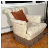 TUFTED ARMCHAIR | Textured fabric upholstery with a tasseled apron mounted on casters - h. 32 x w. 3