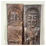 Carved wood wall hanging plaques of saintly figures including St. Francis and a man with bow and arr
