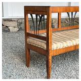 Biedermeier style, this bench features figured wood veneer, the top edge with black paint, chamfered