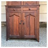  top section with double cabinet doors with vintage hardware, the lower section with two drawers ove