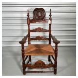 CARVED SHIELD ARMCHAIR  | 19th century, carved wood armchair crested by an intricately carved shield