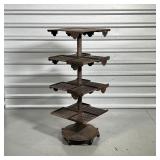 INDUSTRIAL IRON RACK  | Having three open work shelves and a top solid shelf rotating around a centr