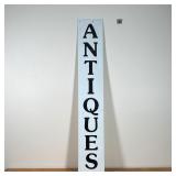 ENAMELED "ANTIQUES" TRADE SIGN  | A white enamel sign reading, "ANTIQUES" in a vertical orientation 