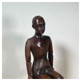 Carved wood seated artist