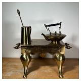 (4pc) MISC. BRASS  | Including a tall pitcher with stirrer, a teapot, and a large trivet - l. 22 x w