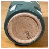 pottery vase with green and white semi-circle design, signed with artist