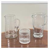 (3pc) CUT GLASS ITEMS  | Blown and/or cut clear glass, including two pitchers and a lidded jar - h. 