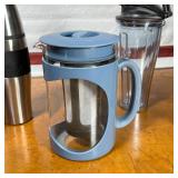 Primula tea pot, a Starbucks travel thermos, a thermos travel cup, a Vitamix blender cup, and a trav