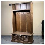 Wood hall tree with hooks for coats, an upper open shelf, and three lower drawers,  the lower sectio