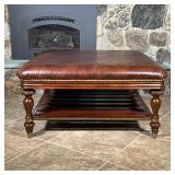 THOMASVILLE LEATHER COFFEE TABLE  | Brown leather padded top with brass tacks, on carved wood legs w
