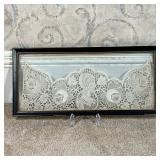 ANTIQUE LACE PANEL  |  Showing a central figure flanked by flowers, framed between glass; w. 18.5 in