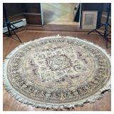 ROUND HAND KNOTTED RUG  |  Round rug with central medallion on a beige field, originally retailed at