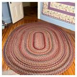 COLORFUL HOOKED RUG  |  Oval shaped multicolor hooked rug - l. 8.75 x w. 7 ft.