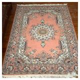 MEDALLION AREA RUG  |  Having a central medallion on a salmon ground with floral arabesque borders -