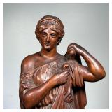 COMPOSITION FIGURE  |  Bronze style composition figure of a woman donning a robe - h. 21 1/4 in.