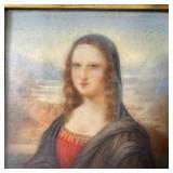 Mona Lisa painted on enamel in an antique possibly gold or gold-plated frame with a scrollwork / she